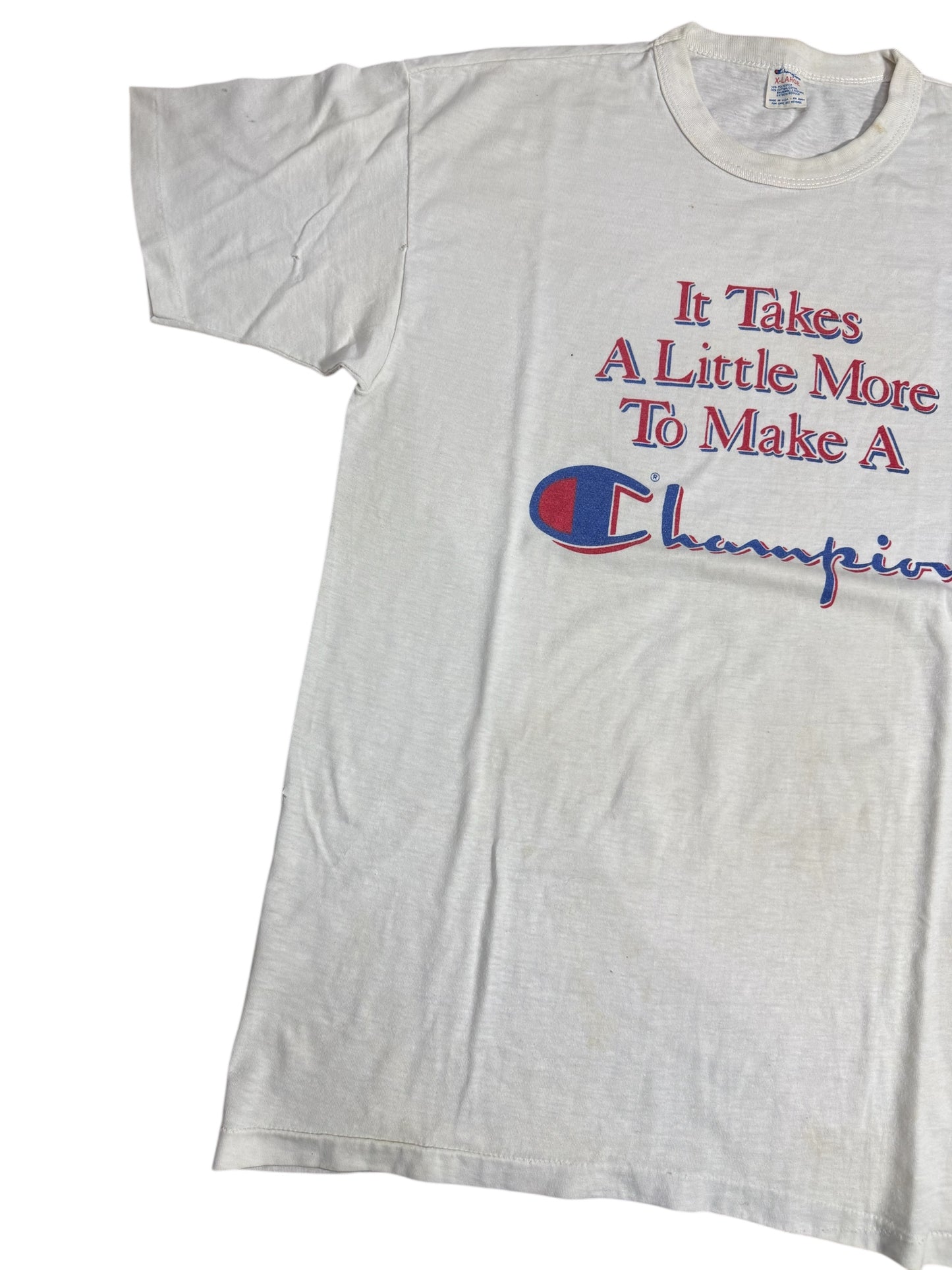 Vintage 1980s Champion Slogan Tshirt “It Takes A Little More To Make A Champion”