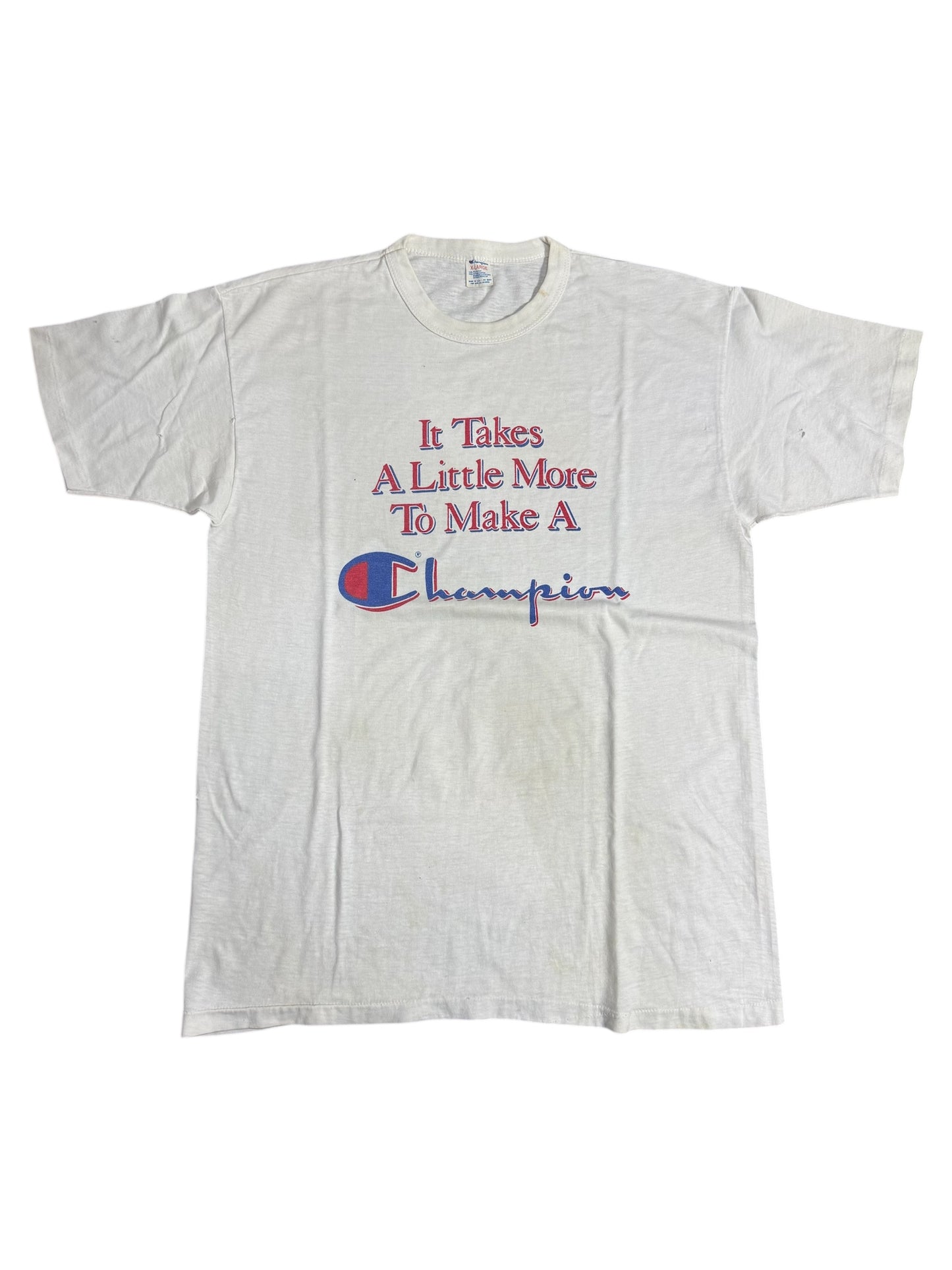 Vintage 1980s Champion Slogan Tshirt “It Takes A Little More To Make A Champion”