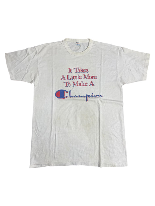 Vintage 1980s Champion Slogan Tshirt “It Takes A Little More To Make A Champion”