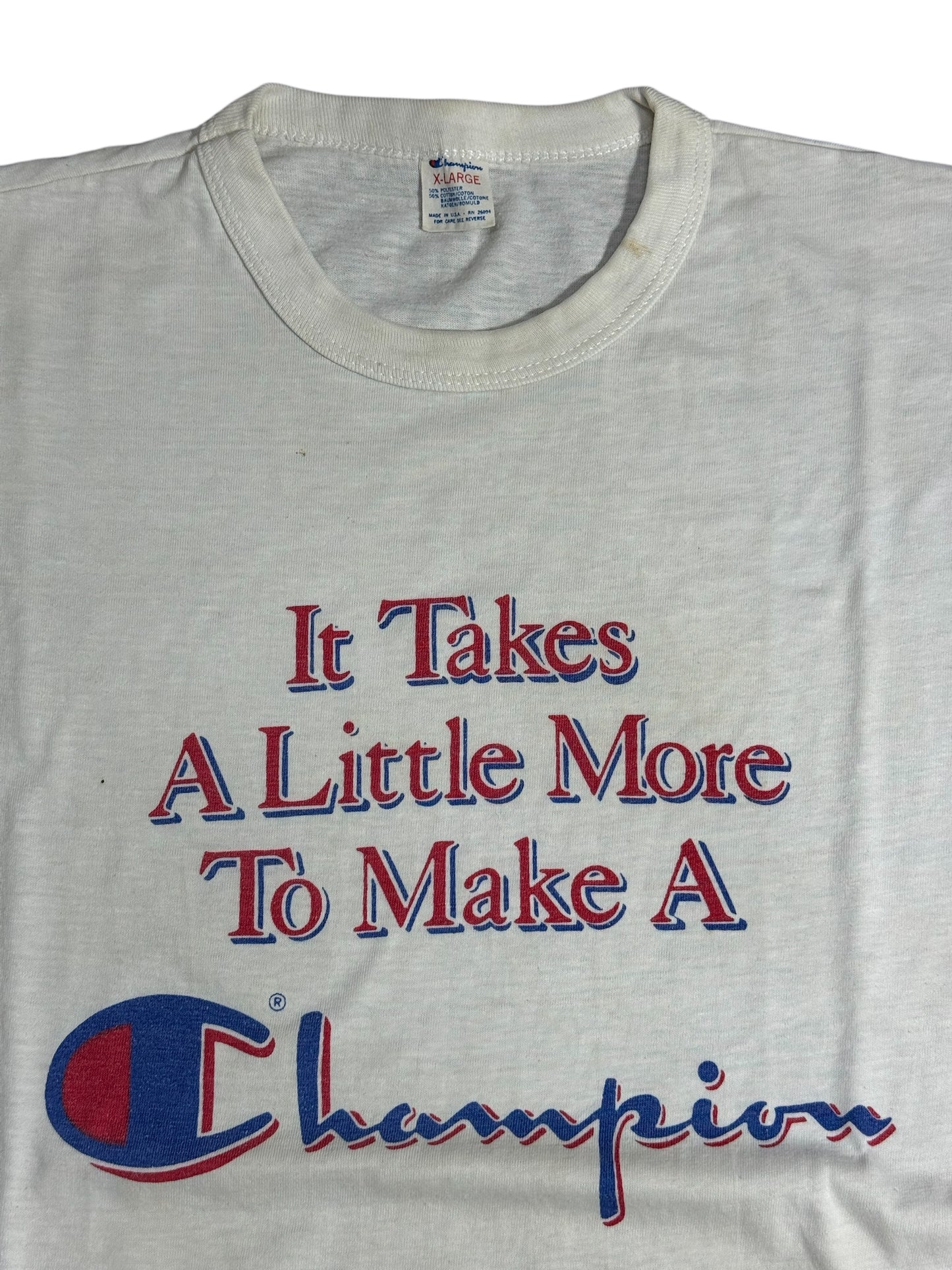 Vintage 1980s Champion Slogan Tshirt “It Takes A Little More To Make A Champion”